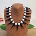 Collier à dents noires et perles blanches mixtes